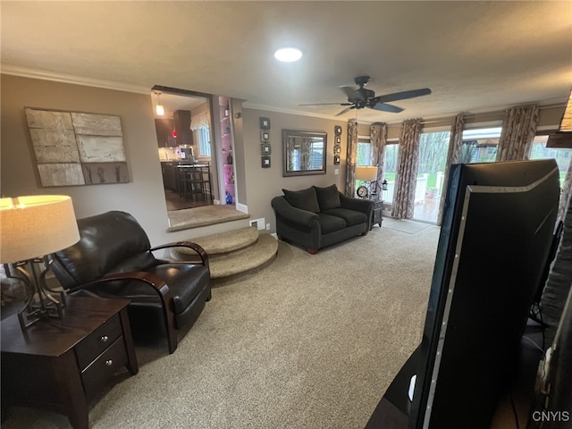 living room featuring ceiling fan, carpet floors, baseboards, ornamental molding, and recessed lighting