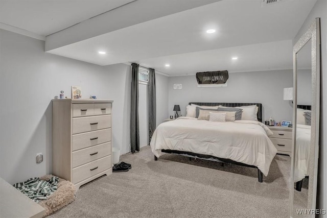 bedroom with light carpet and recessed lighting