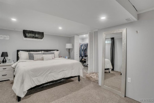 bedroom featuring a spacious closet, carpet flooring, recessed lighting, and visible vents