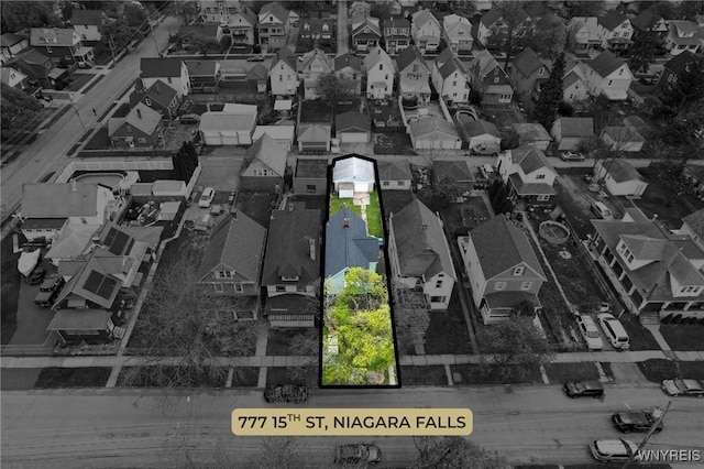 birds eye view of property with a residential view