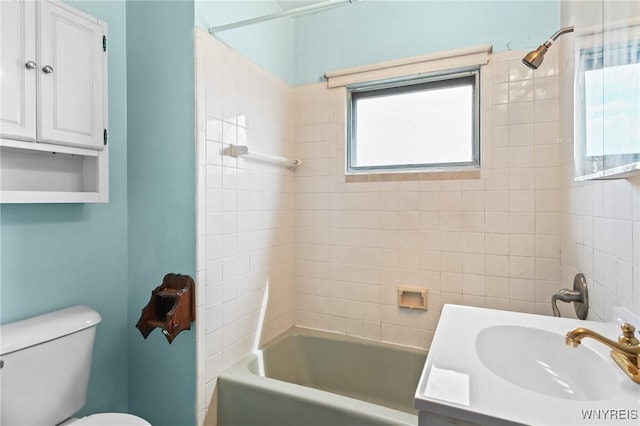 bathroom featuring toilet, shower / washtub combination, and vanity