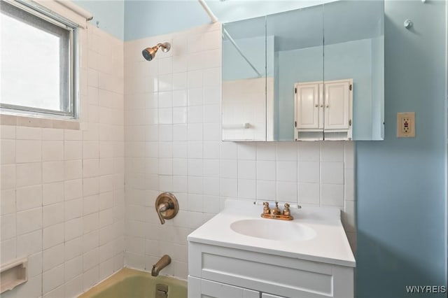 full bath with vanity, backsplash, bathing tub / shower combination, and tile walls