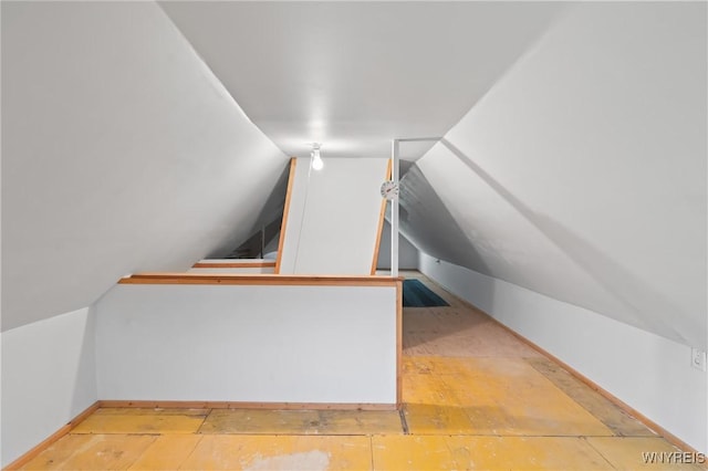 additional living space featuring lofted ceiling