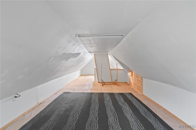 additional living space featuring vaulted ceiling