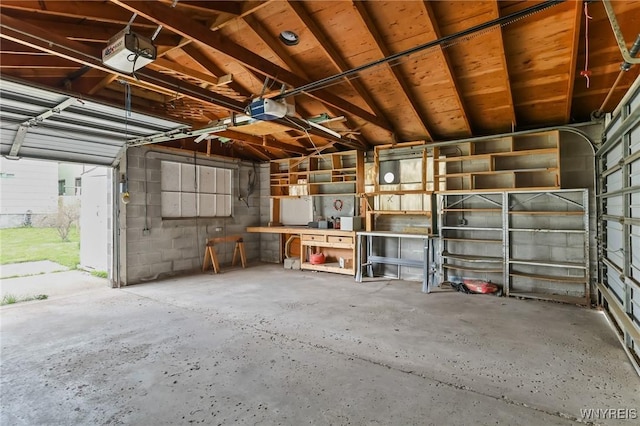 garage with a workshop area and a garage door opener