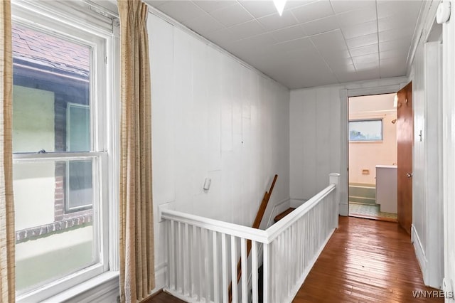 hallway featuring an upstairs landing and hardwood / wood-style flooring