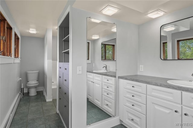 bathroom featuring vanity, tile patterned floors, baseboards, a baseboard heating unit, and toilet