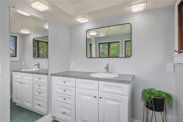 bathroom featuring a healthy amount of sunlight, vanity, and tile patterned flooring