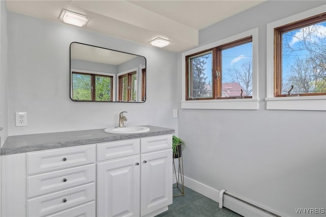 bathroom with baseboards, a baseboard heating unit, tile patterned floors, and vanity