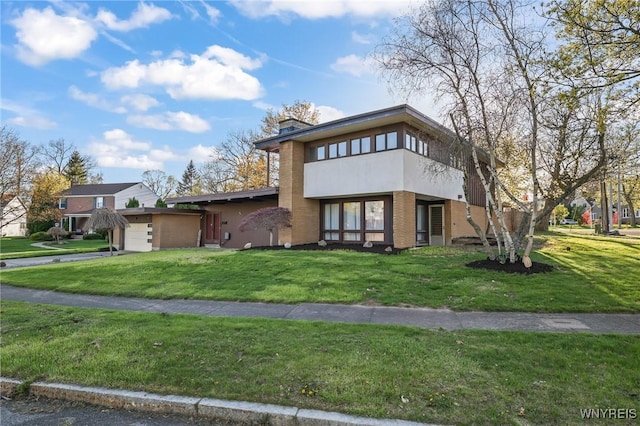 view of front of home with a garage, stucco siding, and a front lawn