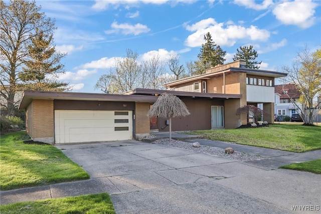 view of front of house with concrete driveway, an attached garage, a front yard, and stucco siding