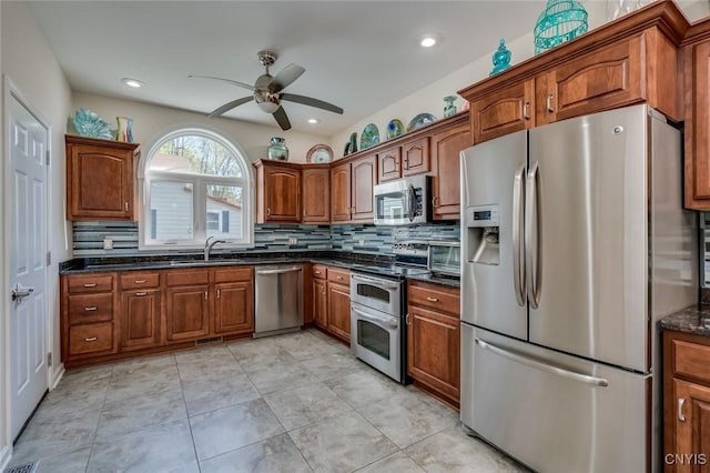 222 William St, Brownville, NY 13634 - kitchen with ceiling fan, brown cabinets, tasteful backsplash, a sink, and appliances with stainless steel finishes