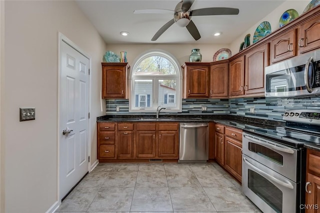 222 William St, Brownville, NY 13634 - kitchen with stainless steel appliances, ceiling fan, decorative backsplash, and a sink