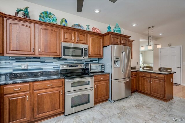 222 William St, Brownville, NY 13634 - kitchen with stainless steel appliances, ceiling fan, and brown cabinetry