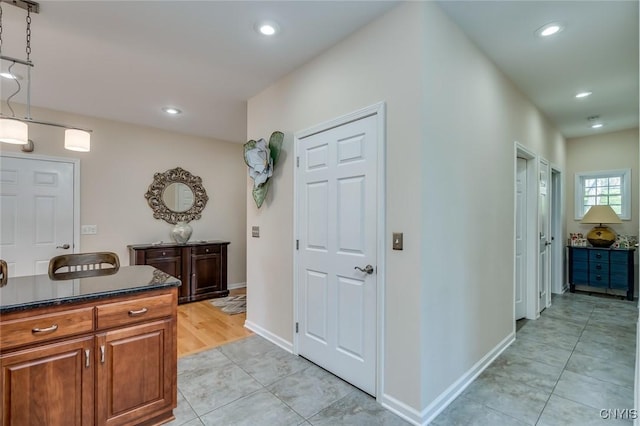 222 William St, Brownville, NY 13634 - kitchen with dark countertops, brown cabinets, light tile patterned floors, baseboards, and recessed lighting
