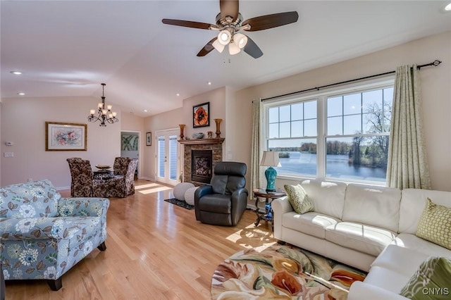 222 William St, Brownville, NY 13634 - living area featuring a glass covered fireplace, ceiling fan with notable chandelier, lofted ceiling, light wood-style floors, and recessed lighting