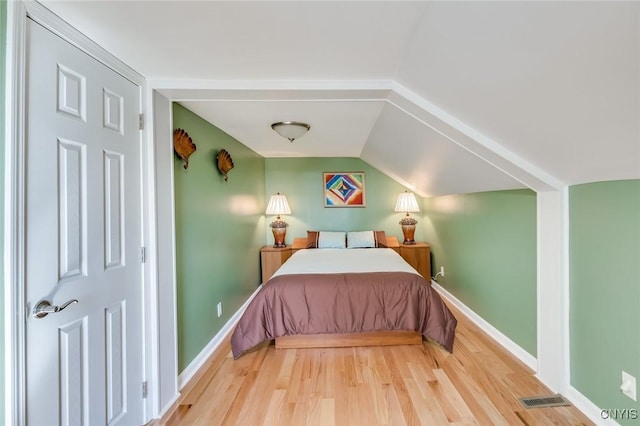 222 William St, Brownville, NY 13634 - bedroom featuring visible vents, baseboards, lofted ceiling, and wood finished floors