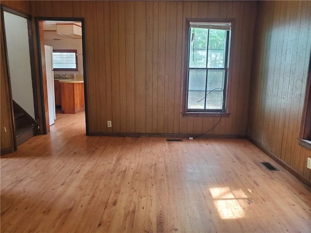 212 Mechanic St, Elmira City, NY 14904 - empty room featuring light wood-type flooring, healthy amount of natural light, and wooden walls