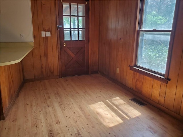 212 Mechanic St, Elmira City, NY 14904 - doorway to outside with light wood-style floors, healthy amount of natural light, and wood walls