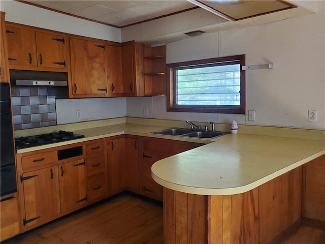 212 Mechanic St, Elmira City, NY 14904 - kitchen with black gas stovetop, a peninsula, under cabinet range hood, light countertops, and crown molding