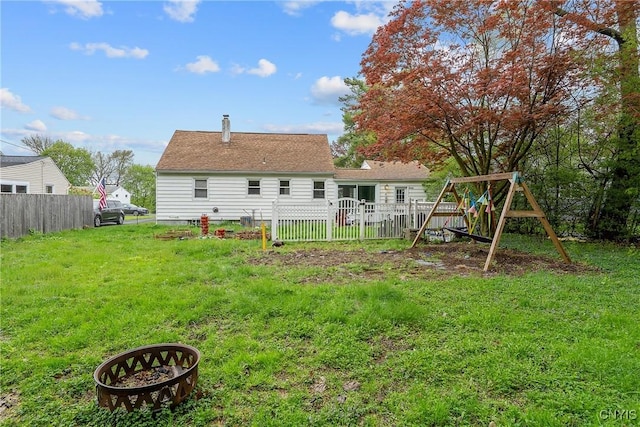 504 Beverly Dr, Camillus, NY 13219 - rear view of house with a lawn, a playground, and fence