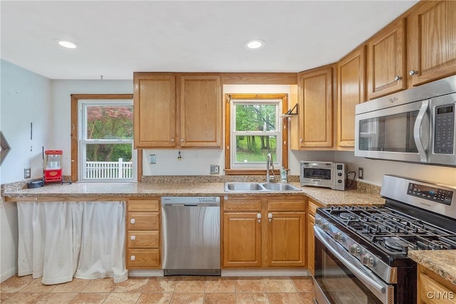 504 Beverly Dr, Camillus, NY 13219 - kitchen featuring a sink, light countertops, stainless steel appliances, recessed lighting, and a toaster
