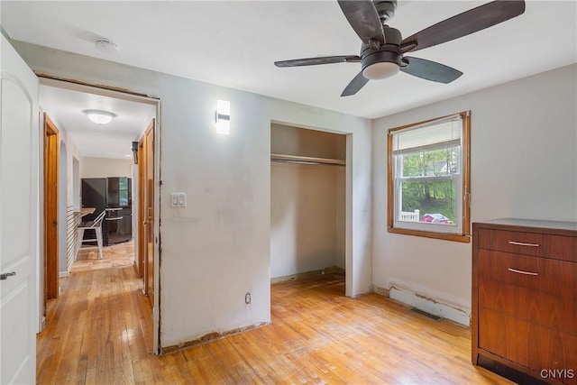 504 Beverly Dr, Camillus, NY 13219 - unfurnished bedroom featuring ceiling fan, light wood-style floors, freestanding refrigerator, baseboards, and a closet