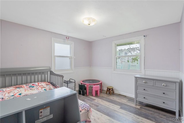 504 Beverly Dr, Camillus, NY 13219 - bedroom featuring wood finished floors, a wainscoted wall, and visible vents