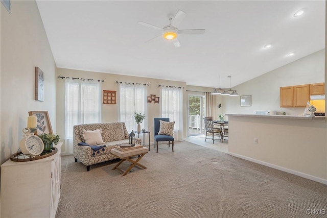living room with ceiling fan, baseboards, lofted ceiling, light carpet, and recessed lighting