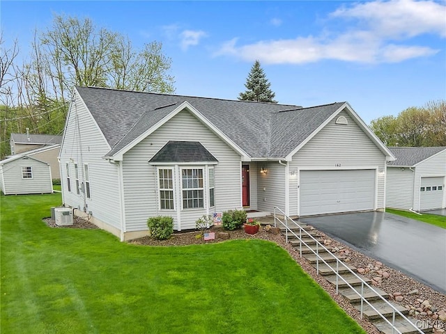ranch-style home with roof with shingles, central AC unit, driveway, and a garage