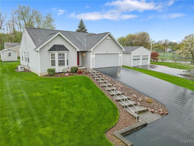 single story home with a garage, a front lawn, aphalt driveway, central AC, and roof with shingles
