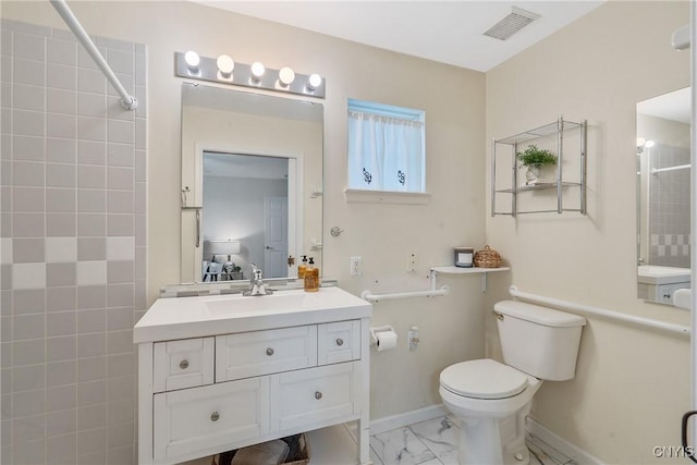 bathroom with vanity, toilet, marble finish floor, baseboards, and visible vents