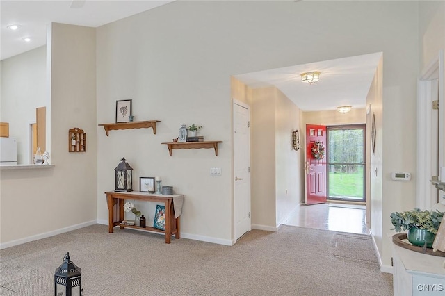 corridor featuring baseboards and carpet flooring
