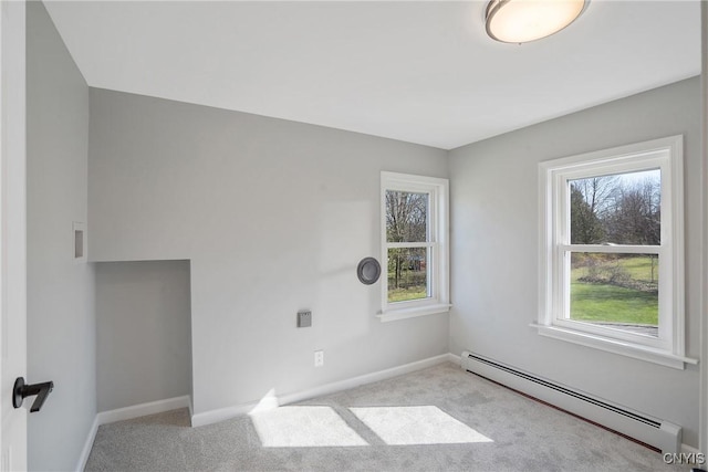unfurnished room featuring carpet, baseboards, and baseboard heating