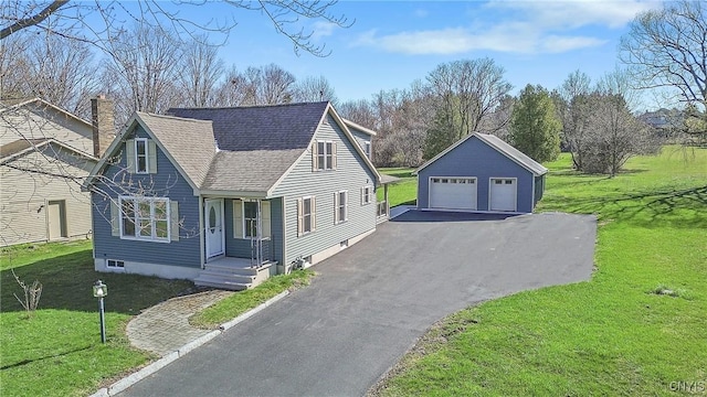 view of front of property featuring a chimney, a front yard, roof with shingles, an outbuilding, and a garage