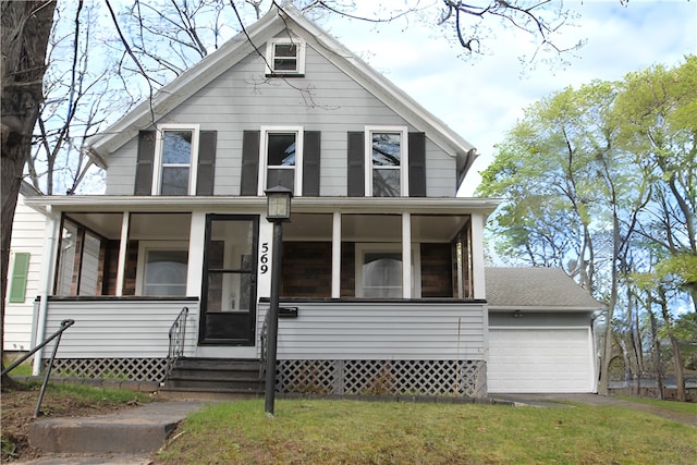 view of front facade featuring entry steps, a sunroom, an attached garage, and a front yard