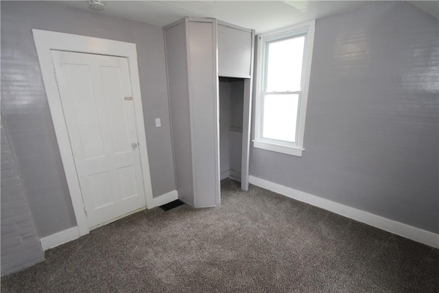 unfurnished bedroom with carpet floors, baseboards, and a closet