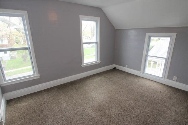 bonus room featuring vaulted ceiling, carpet floors, baseboards, and plenty of natural light