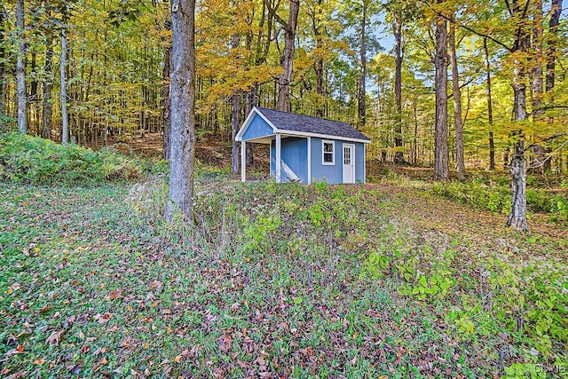 view of shed with a forest view