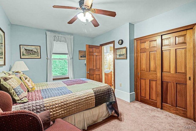 bedroom with a ceiling fan, carpet flooring, ensuite bath, and a closet