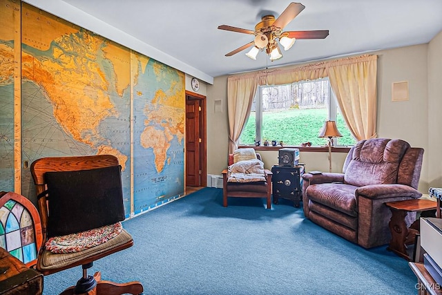 sitting room with ceiling fan and carpet