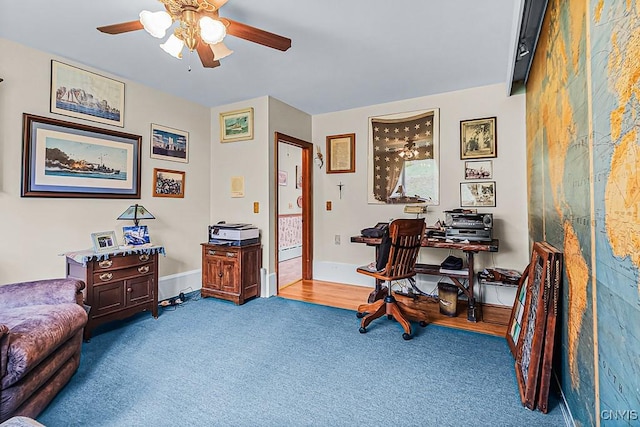 office space with baseboards, a ceiling fan, and carpet floors