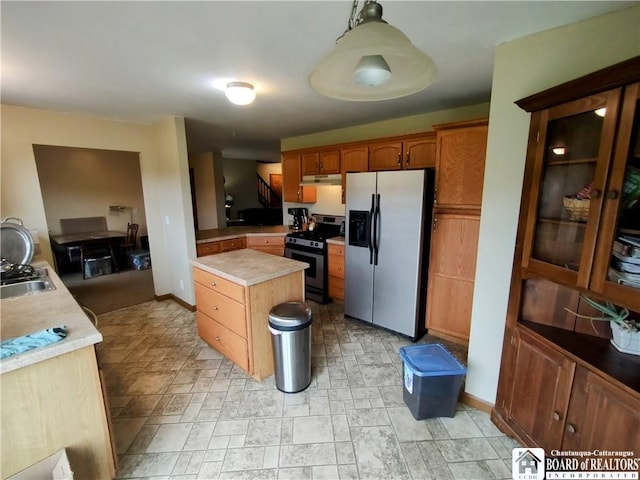 804 Smith Rd, Villenova, NY 14062 - kitchen featuring stainless steel appliances, light countertops, under cabinet range hood, a kitchen island, and baseboards