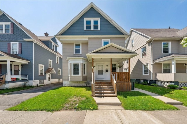 traditional style home with a front yard and covered porch
