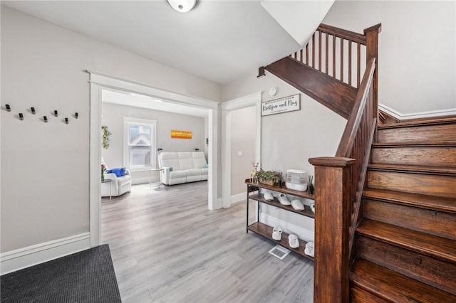 stairs featuring visible vents and wood finished floors