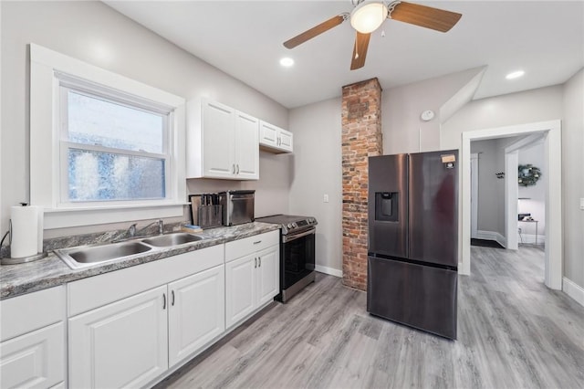 kitchen featuring stainless steel appliances, baseboards, a ceiling fan, and a sink