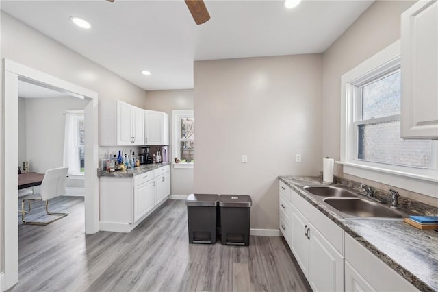 kitchen featuring a sink, recessed lighting, light wood finished floors, ceiling fan, and white cabinets