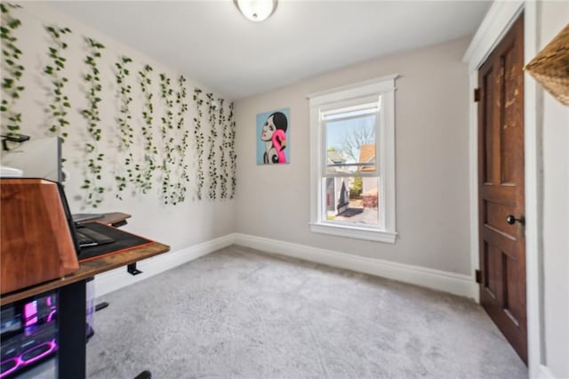 unfurnished office featuring carpet and baseboards