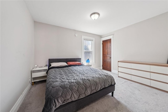 carpeted bedroom featuring baseboards