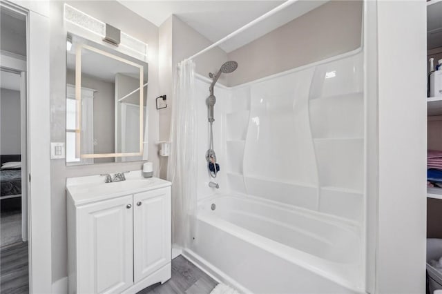 full bathroom with vanity, ensuite bathroom, wood finished floors, and shower / bath combo